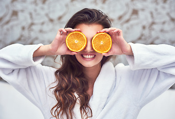 Image showing Orange, beauty and smile with woman in hotel for breakfast, diet and relax. Nutrition, health and natural with female model and cover with citrus fruit in bedroom for vitamin c, spa and facial