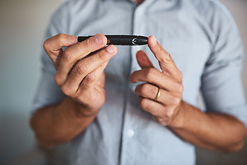 Image showing Hands, diabetes and insulin injection with a man closeup in his home for routine treatment of glucose. Health, wellness and blood sugar with a male diabetic taking a medical sample in his house