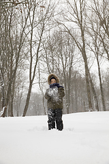 Image showing boy plays with snow