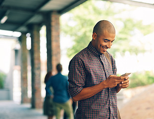 Image showing Young man, student and texting with cellphone on campus, university and happy with social media app. Guy, smartphone and happiness outdoor for connectivity, blog and email communication on internet