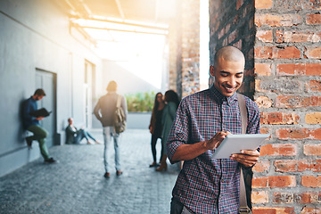 Image showing Happy, outdoor and man with a tablet, education and connection for social media, search website for information or network. Male person, guy and student with technology, campus and typing with an app