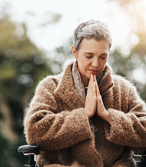 Image showing Old woman in wheelchair, praying in garden with worship and God, faith and religion with peace outdoor. Spiritual, female person with disability has gratitude and faith, prayer and guidance