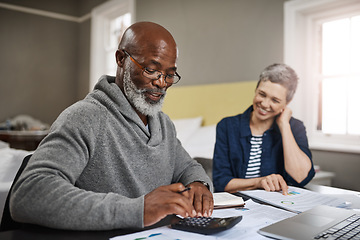 Image showing Calculator, documents or finance with an old couple busy on a budget review in the home together. Accounting, taxes or investment with a senior man and interracial woman planning insurance or savings