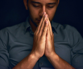 Image showing God, worship and man with hands praying for hope, guidance or spiritual healing in a dark studio. Pray, thank you and Christian man in prayer for help, faith or gratitude and praise to Jesus christ