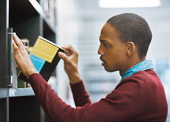 Image showing Education, university and student in the library picking a book or on shelf for exam preparation and in college. Research, learning and scholar browsing journal or academic and educational course