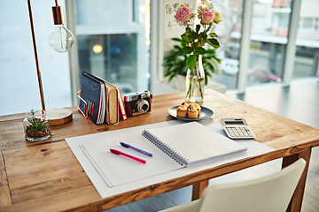 Image showing Remote work, book and desk in creative workplace with paper for writing, planning and idea inspiration. Notebook, space and workspace table for freelance business in home office room for creativity