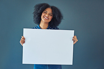 Image showing Happy, mockup and portrait of a woman with a sign isolated on a blue background in studio. Smile, showing and young corporate copywriter with a blank board for branding, design and information space