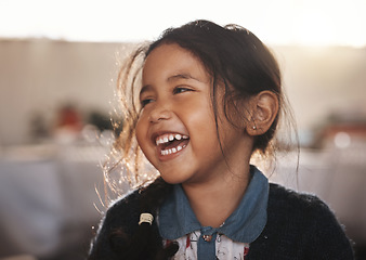 Image showing Happy, kid and girl laughing in a living room, playing and having fun in her home. Child, development and Mexican female toddler with funny, joke or reaction to comedy, goofy and crazy in her house