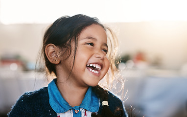 Image showing Happy kid, laughing and girl in a living room, playing and having fun in her home. Child, development and Mexican female toddler with funny, joke or reaction to comedy, goofy and comic in her house