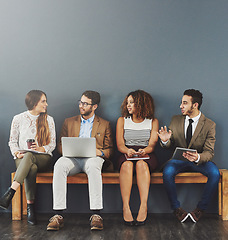 Image showing Business people, we are hiring talk and conversation before a job interview waiting and sitting in line. Communication, technology and staff in discussion for recruit meeting with mockup wall