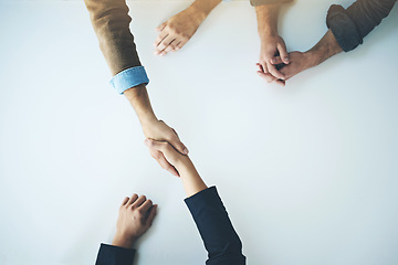 Image showing Handshake, agreement and business people in partnership, support and trust together for business consulting. Above, collaboration and team in negotiation, welcome or deal with witness at table