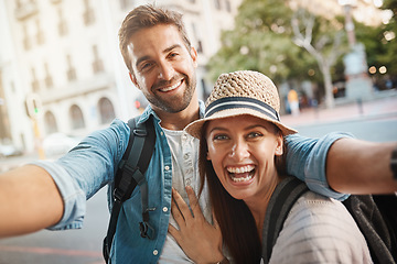 Image showing Happy couple, tourist and selfie in a city for travel on street with holiday memory and happiness. Portrait of man and woman outdoor on urban road for adventure, social media or vacation photo