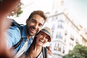 Image showing Tourist couple, selfie and happy in a city for travel on a street with a partner for holiday memory. Face of a man and woman outdoor on urban road for adventure, journey or vacation photo for freedom