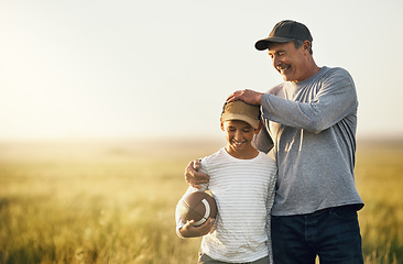 Image showing Father, son and rugby ball in a countryside field for bonding and fun in nature. Mockup, dad and young child together with happiness and smile ready to start American football game outdoor on farm