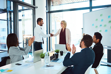 Image showing Congratulations, handshake and professional with support at a meeting for teamwork and collaboration at a company. Business people, applause and presentation with success for agreement in office.