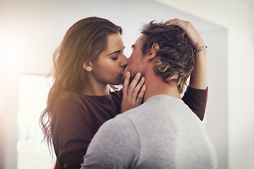 Image showing Couple, love and kissing in home for romantic bond, quality time and care together. Young man, woman and kiss for romance of lovers in happy relationship, intimate moment and passionate affection