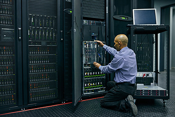 Image showing Database, software and a man engineer in a server room for cybersecurity maintenance on storage hardware. Computer network or mainframe with a technician working on information technology equipment