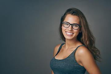 Image showing Smart woman, glasses and portrait with happiness and mockup from eyewear. Gray background, studio and modern style with female person and model with beauty and casual fashion with smile and eye care