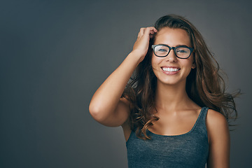 Image showing Young woman, glasses and portrait with happiness and mockup from eyewear. Gray background, studio and mockup with female person and model with beauty and casual style with a smile and eye care