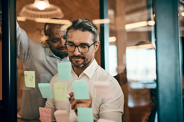 Image showing Businessman, writing and schedule planning in meeting for strategy, brainstorming or tasks at office. Man employee in leadership, presentation or training staff in team project plan at the workplace