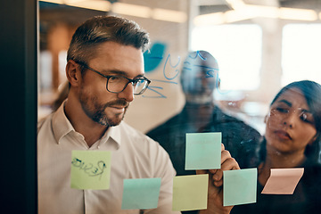 Image showing Businessman, writing and planning in meeting for strategy, brainstorming or schedule task at office. Man employee in leadership, presentation or training staff on sticky note for project at workplace