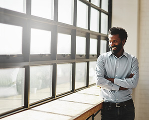 Image showing Window, flare and a business man arms crossed in the office with a smile or mindset of future success. Happy, vision and corporate with a male employee standing in the workplace during his break