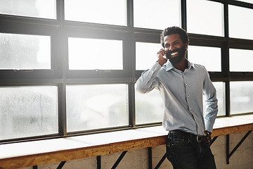 Image showing Window, phone call or idea and a business man in the office with a smile while planning or networking. Happy, vision and mobile contact with a male employee standing in the workplace during his break