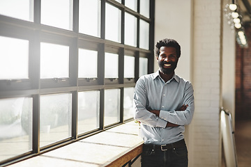 Image showing Portrait, window and a business man arms crossed in the office with a smile or mindset of future success. Flare, vision and corporate with a happy male employee standing at work during his break