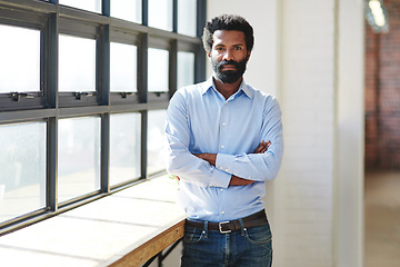 Image showing Portrait, window and a business man arms crossed in the office with a mindset of focus on future success. Serious, vision and corporate with a male employee standing in the workplace during his break