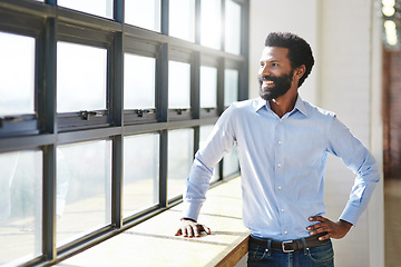 Image showing Window, idea and smile with a business man in the office to focus on company growth or success. Happy, vision and thinking with a male employee standing hand on hip in the workplace during his break