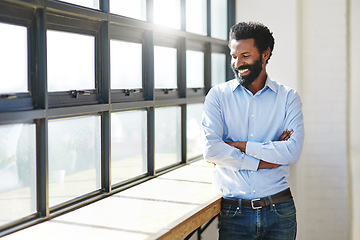 Image showing Window, lens flare and a business man arms crossed in the office with a smile or mindset of future success. Happy, vision and thinking with a male employee standing in the workplace during his break