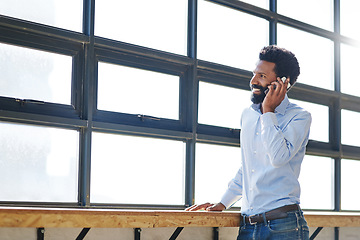 Image showing Window, smile and phone call with a business man thinking about the future success of his company in the office. Happy, mindset and communication with a male employee chatting on his mobile at work
