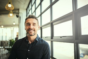 Image showing Portrait, smile and happy man at office window, creative startup and business project for entrepreneur at design agency. Proud boss with creativity, job ideas and focus, businessman with confidence.