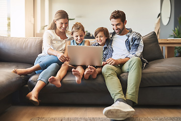 Image showing Family, laptop and kids with parents on a living room sofa with education game online. Mom, dad and young children together with bonding, parent care and love in a house watching a video on computer