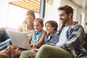 Image showing Family, laptop and kids smile with parents on a living room sofa with education game online. Mom, dad and young children together with bonding, care and love in a house streaming a video on computer