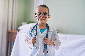 Image showing Girl child, portrait and playing doctor with smile, glasses and holding stethoscope in home, hospital or clinic. Female kid, play medic and happy with excited face, learning and game for development