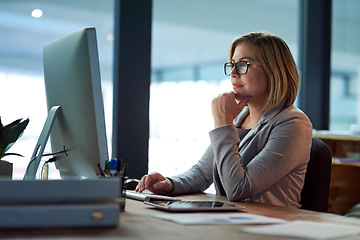 Image showing Computer, thinking and business woman in office working late on project at night alone. Desktop, professional and female person problem solving, focus or solution, planning or reading on deadline