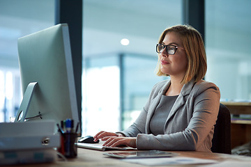 Image showing Computer, typing and business woman in office working late on project at night alone. Desktop, professional and female person writing email, report or planning, reading and overtime for deadline.