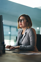 Image showing Desktop, typing and business woman in office, working late on project and focus at night. Computer, professional and female person writing email, report or planning, reading and overtime for deadline