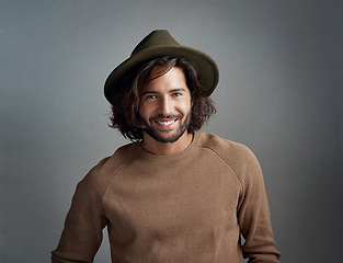 Image showing Portrait, hat and smile of man in studio isolated on a gray background. Face, fedora and handsome male person or model from Australia with happiness for fashion, stylish and trendy aesthetic mockup.