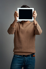 Image showing Tablet screen, mockup and man covering face in studio isolated on a gray background. Touchscreen, hiding and male person with space for marketing, advertising and technology for commercial promotion.