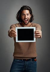 Image showing Portrait, tablet screen and excited man with mockup in studio isolated on a gray background. Touchscreen, face and male person with marketing, advertising and technology for surprise promotion.