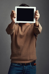 Image showing Space, tablet screen and man covering face in studio isolated on a gray background. Touchscreen, hiding and male person with mockup for marketing, advertising and technology for commercial promotion.