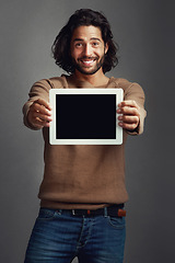 Image showing Tablet screen, portrait and smile of man with mockup in studio isolated on a gray background. Touchscreen, face and male person with marketing, advertising and technology for commercial promotion.