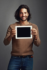 Image showing Portrait, tablet screen and smile of man with mockup in studio isolated on a gray background. Touchscreen, face and male person with marketing, advertising and technology for commercial promotion.