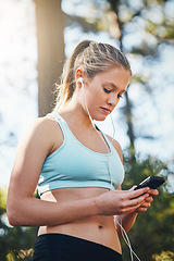 Image showing Woman with earphones, smartphone and fitness with music outdoor, listening for motivation on run in park. Female runner with song choice, podcast or radio streaming with exercise, focus and health