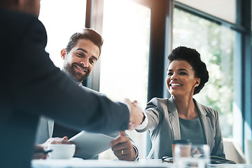 Image showing Business people, handshake and meeting for partnership, teamwork or collaboration in boardroom at office. Happy woman shaking hands in team recruiting, introduction or b2b agreement at the workplace