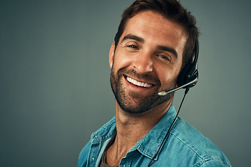 Image showing Happy man, portrait and headphones for call center consulting against a grey studio background. Face of friendly male consultant agent with smile and headset in contact us for help or online advice