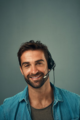 Image showing Happy man, call center and consultant with headphones on mockup space against grey studio background. Portrait of friendly male consulting agent with smile and headset in contact us for online advice