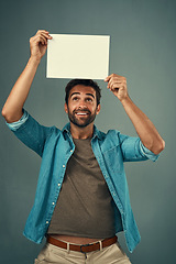 Image showing Happy man, poster and mockup billboard for advertising, marketing or branding against a grey studio background. Male person holding blank shape placard or board for sign, message or advertisement